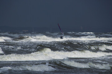 Windsurfer among waves in stormy weather at Melbystrand, Sweden
