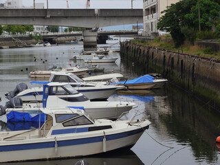 Boats on the river are moored behind the residential area.