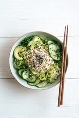 Cold ramen salad bowl with cucumbers, lettuce, avocado slices, and sesame dressing in pastel bowl