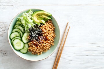 Cold ramen salad bowl with cucumbers, lettuce, avocado slices, and sesame dressing in pastel bowl
