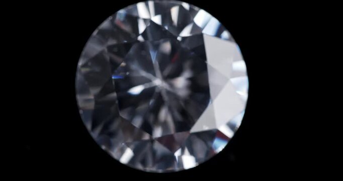 Jewelry zirconia stone on a dark background. Artificial gemstone on a rotating table.