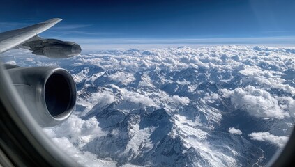Aerial view of snow-capped mountains from an airplane window (1)