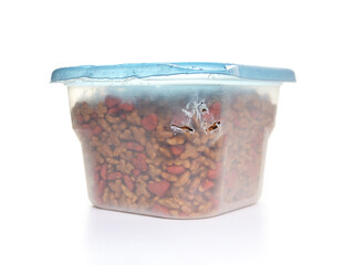 Pet food container with bite marks from cat. Plastic container with kibbles or snacks. Heavy chewed...