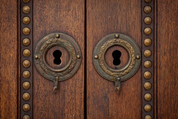 Ornate wooden doors with keyholes