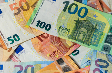 Closeup of Euro banknotes on wooden table surface
