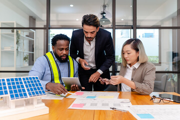 team of multiethnic coworker meeting on solar roof system project with solar panel house model, responsibility of green industry alternative renewable clean environment energy for sustainable business