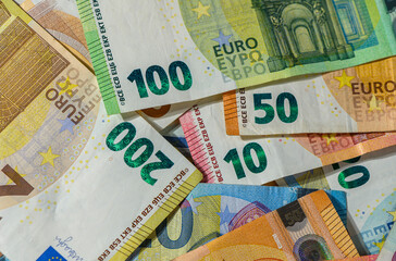 Different Euro denominations lying flat on table closeup