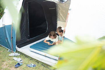 Family camping trip with kids enjoying time together inside a tent