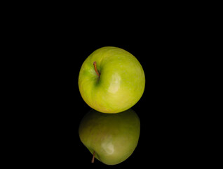 Juicy green apples isolated on black background, close-up.