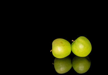 Juicy green apples isolated on black background, close-up.