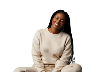 Smiling black woman in beige sweatshirt sitting cross legged, isolated on transparent background