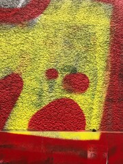 Red and yellow Berlin graffiti street art close up texture