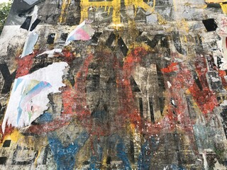 Colorful peeling posters distressed paper texture graffiti detail urban decay wallpaper background