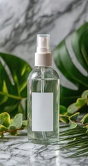 Clear spray bottle amidst tropical foliage