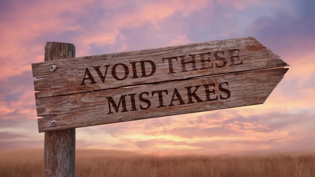of a sunset with signpost warning to avoid mistakes.