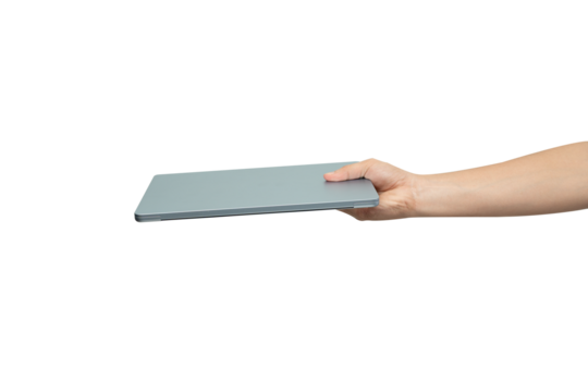 A person's hand is holding the corner of a thin, modern laptop or tablet, showing the side profile of the device. The image is isolated on a pure white background, making it easy to use for various de