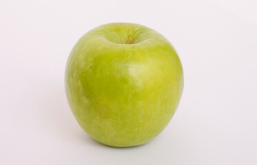A vibrant green apple against a clean white background.