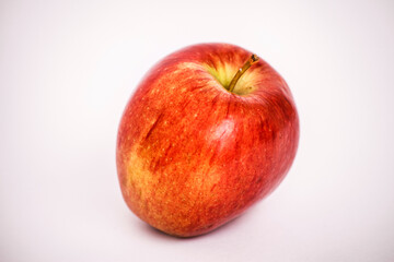 A vibrant red apple isolated against a clean white background.