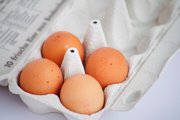 Close-up of brown eggs in a carton