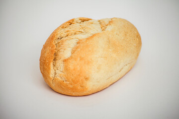 Freshly baked bread roll on a white surface