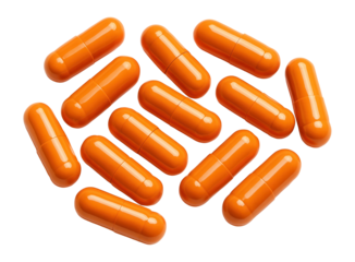 Bulk orange capsule pills on white background.