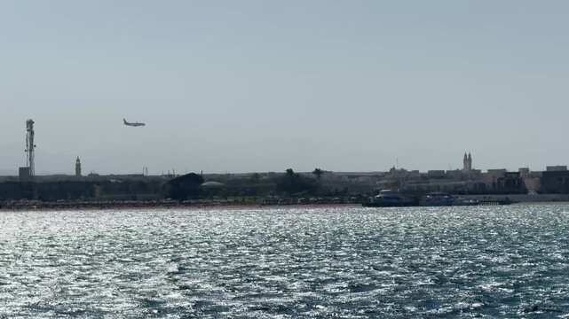 The airplane flying over the sea