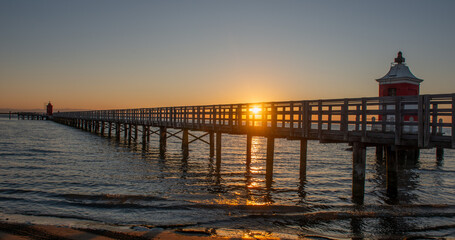 Fototapeta premium The old red lighthouse of Lignano Sabbiadoro at sunrise