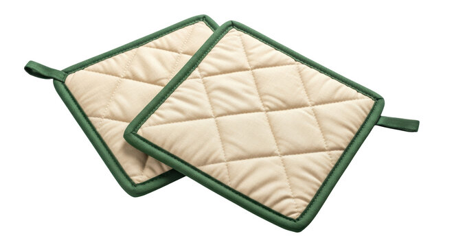 Isolated pair of beige quilted potholders with green trim for kitchen cooking utensils