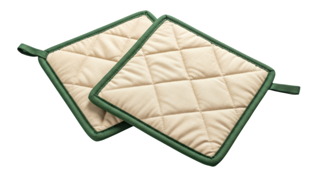 Isolated pair of beige quilted potholders with green trim for kitchen cooking utensils