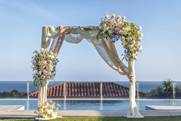 Elegant Wedding Arch Overlooking Ocean With Floral Decorations