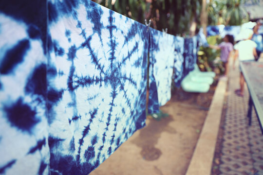 Handmade Indigo Tie-Dye Fabrics. Artisanal Tie-Dye Cloth Drying in the Sun. Natural Indigo Dyeing Process