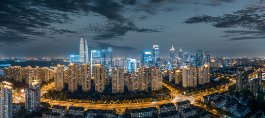 Aerial view of modern city commercial buildings and residential apartments with illuminated skyline...