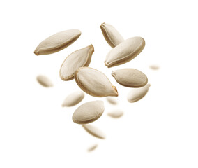 Pumpkin seeds levitate on a white background