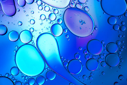 Close up of oil drops on water surface. Colorful abstract macro background of oil drops on water surface with air bubbles inside. Colorful background for gadget and computer wallpaper - Powered by Adobe