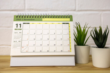 Hello, November 2025. A desktop calendar for planning on the table.