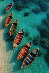 Aerial view of vibrant wooden boats floating on crystal-clear turquoise waters