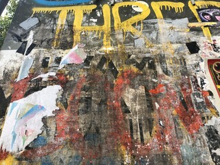 Fototapeta premium Colorful peeling posters distressed paper texture graffiti detail urban decay wallpaper background