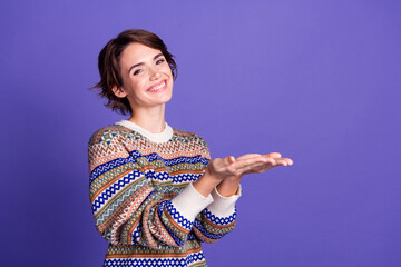 Photo of charming pretty woman wear stylish clothes hold empty space isolated on purple color...