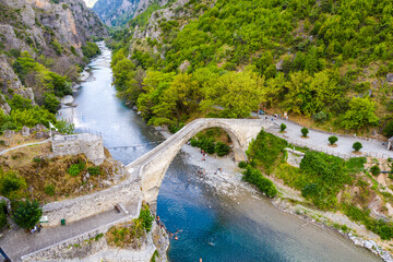 Traditional Stone Bridge in Konitsa The Grand Single Arch Bridge at the Entrance of Aoos Gorge Historic Landmark and Scenic Nature in Greece Featuring Picturesque Views and Cultural Significance