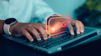 Hands typing on laptop with 5G technology concept for fast internet and digital communication