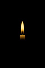 Single glowing candle on soft green backdrop—serene minimal image for memorials, prayer cards, vigils, and calming designs.