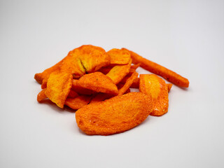 A pile of crunchy carrot chips made from real vegetables, showcasing vibrant orange color. Great for organic snack, vegan food, and clean eating lifestyle themes