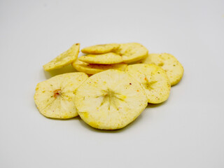 A pile of crispy dried apple slices showing fresh texture and natural color. Ideal for diet food, organic snack, vegan diet, and plant-based nutrition themes