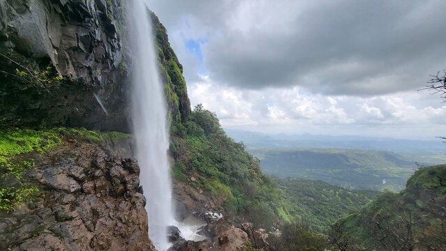 Lakshmi waterfall with clouds in the background near Kelad, Pune