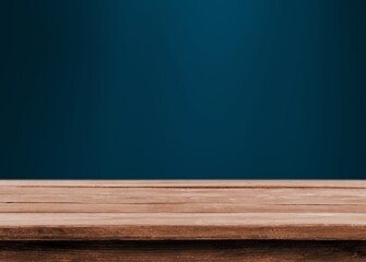 Empty wooden desk top and blue wall background
