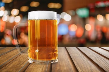 Refreshing pint of cold beer with foam in bar