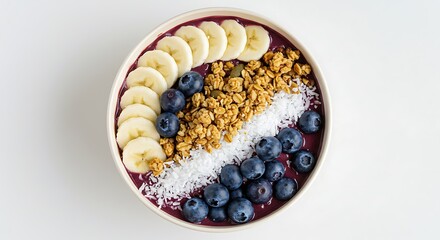 Vibrant acai bowl topped with blueberries, banana slices, granola, and coconut flakes.