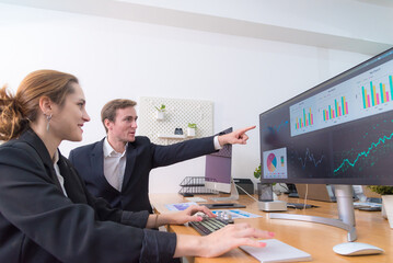 Efficient teamwork modern office setting showcases woman and man collaborating data analysis. atmosphere is focused and professional, highlighting importance of communication and technology.
