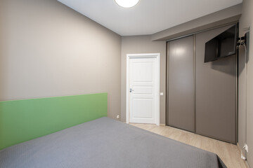 Modern Minimalist Bedroom Interior with Green and Gray Accents and Wooden Floor