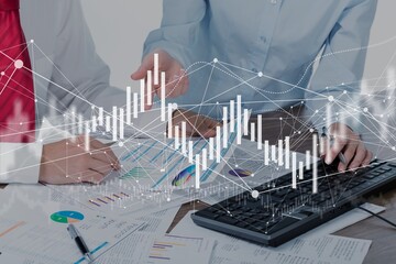 Business meeting with documents and graphs on desk